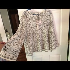 Flowy pleated yoke blouse.Crew neck. Bracelet length bell sleeves.